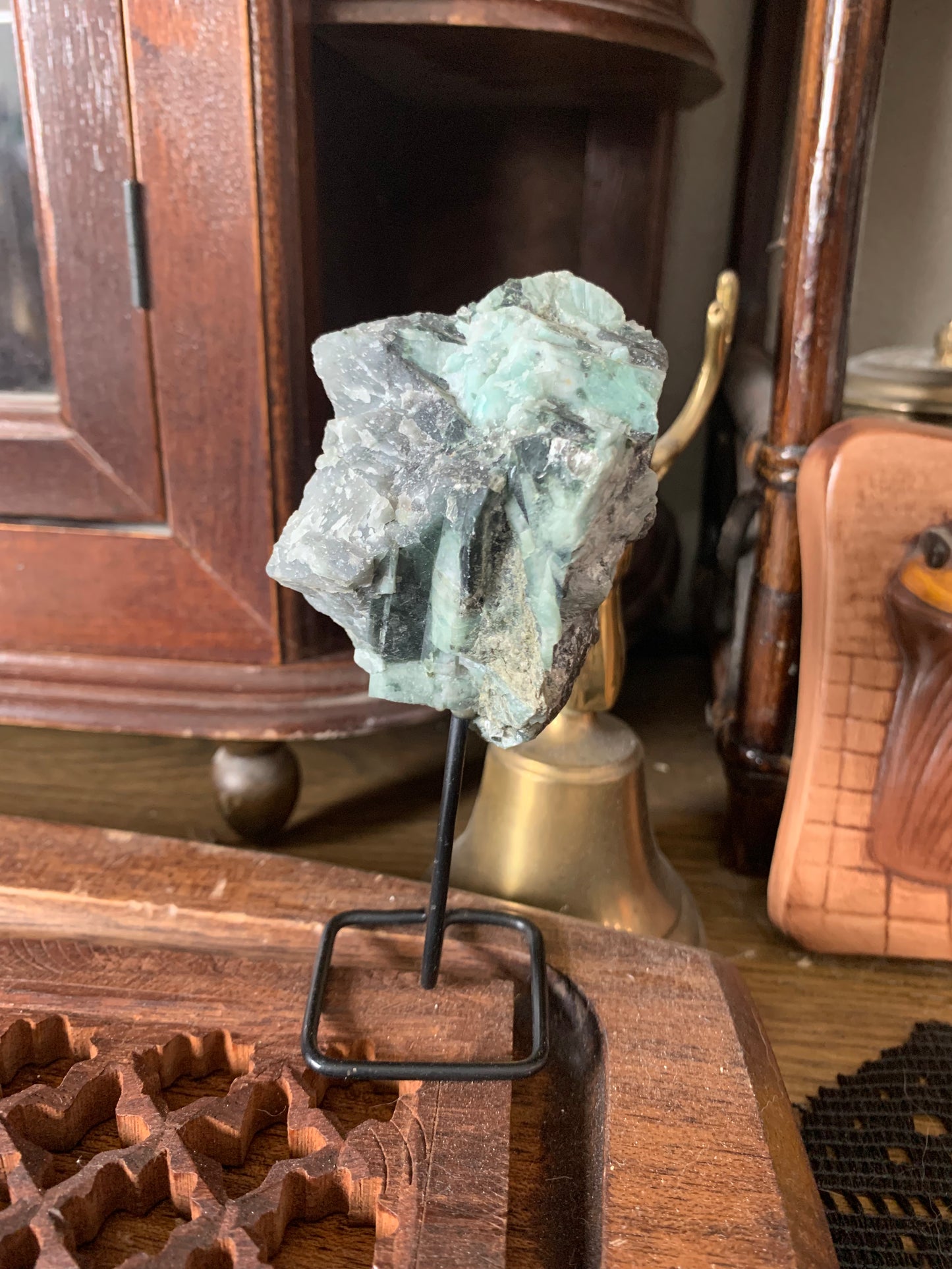 raw emerald on stand
