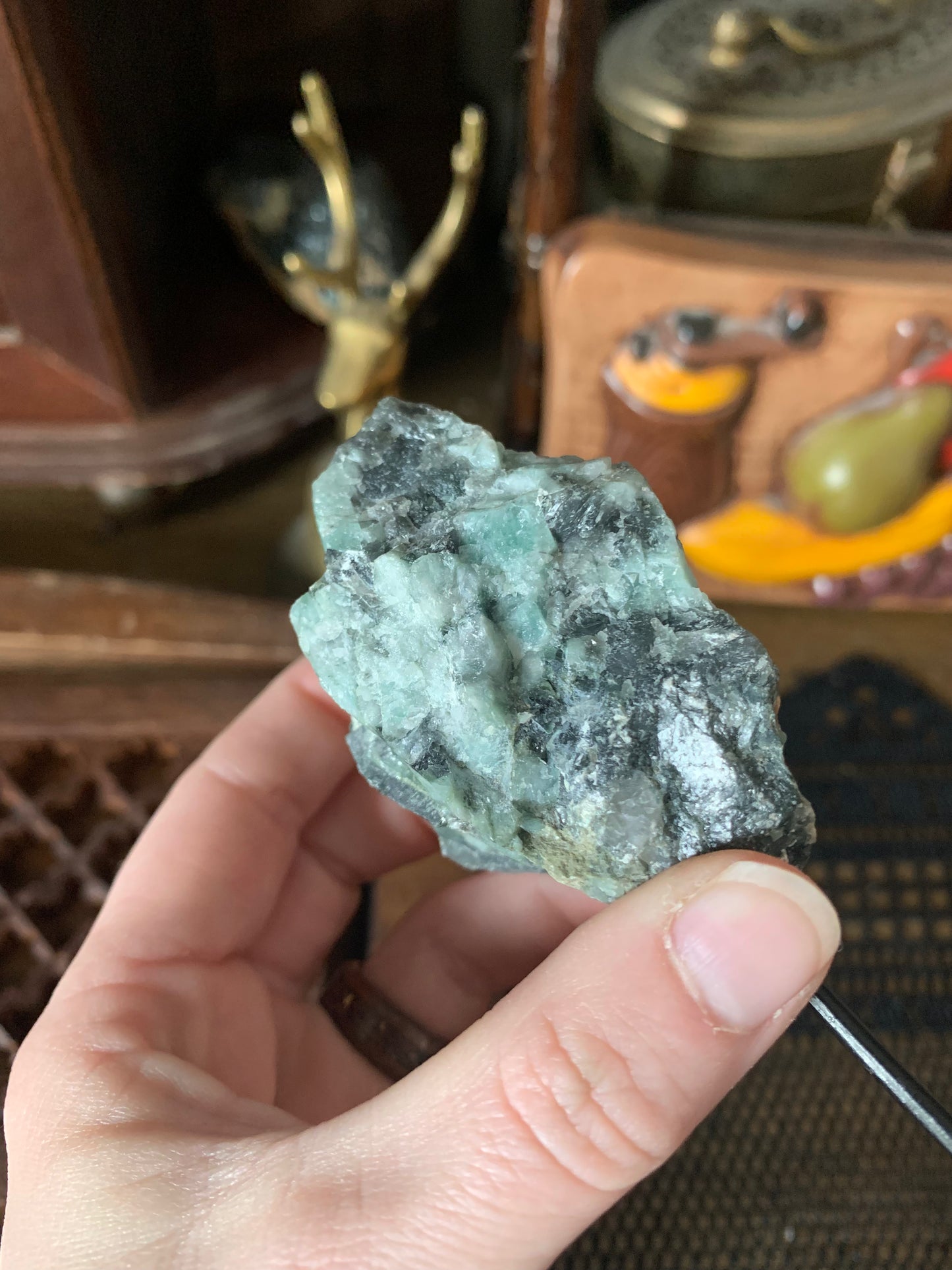 raw emerald on stand